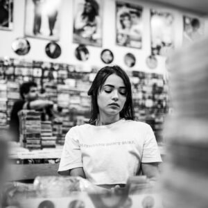 Monochrome Photography of Woman in Music Store