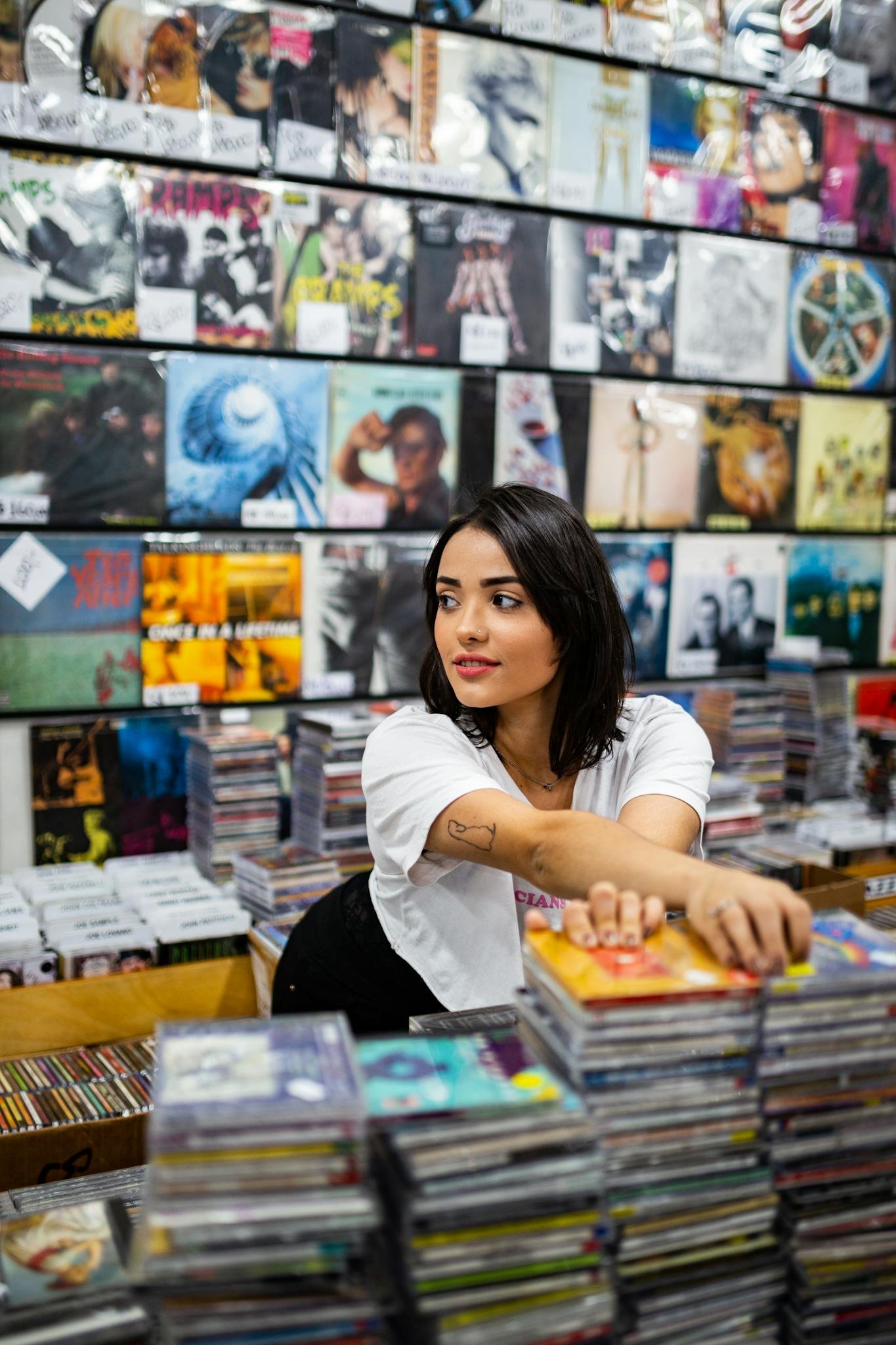 Photo of Woman Standing Near Cds